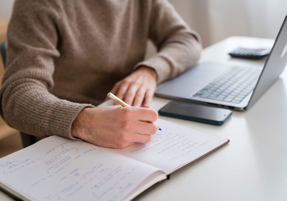 student taking notes in a class